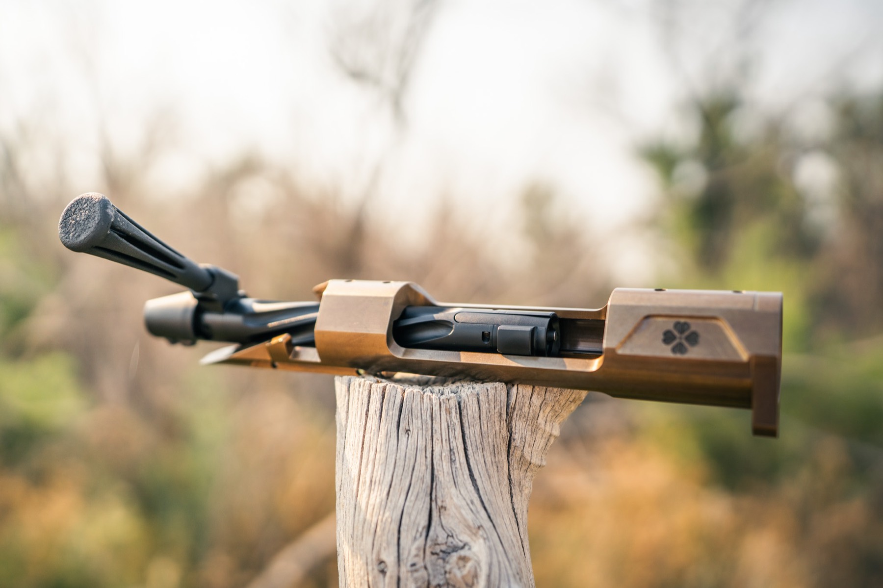 KLOVR barrelled action with bolt, on a cedar post